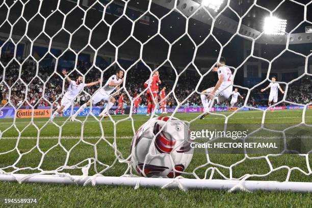 Tajikistan's players celebrate their second goal during the Qatar 2023 AFC Asian Cup Group A football match between Tajikistan and Lebanon at the...