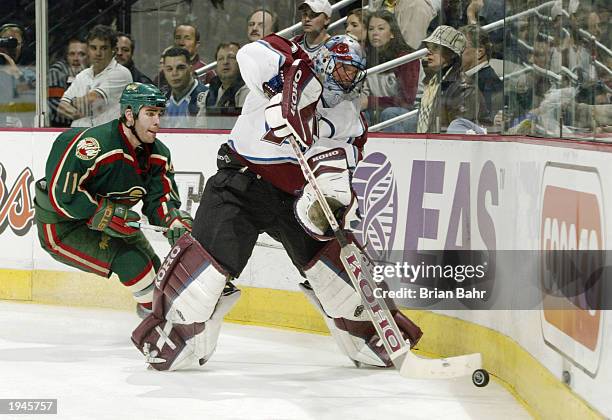 Pascal Dupuis of the Minnesota Wild pressures goalie Patrick Roy of the Colorado Avalanche as he clears the puck in the second period during game...