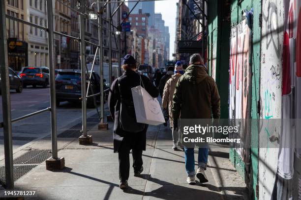 Shopper carries a Prada bag in the Soho neighborhood of New York, US, on Monday, Jan. 22, 2024. US consumers rang in the new year with a good dose of...