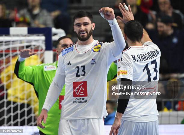 France's pivot Ludovic Fabregas and France's left back Nikola Karabatic celebrate during the Men's EURO 2024 EHF Handball European Championship main...