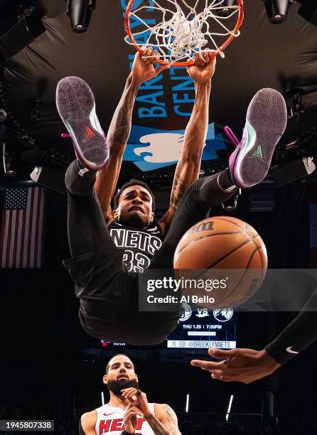 Nic Claxton of the Brooklyn Nets dunks against Caleb Martin and Jamal Cain of the Miami Heat during their game at Barclays Center on January 15, 2024...