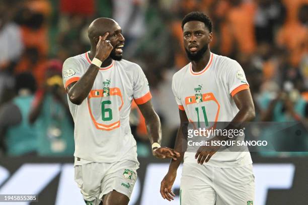 Ivory Coast's midfielder Seko Fofana and Ivory Coast's forward Jean Philippe Krasso react during the Africa Cup of Nations 2024 group A football...