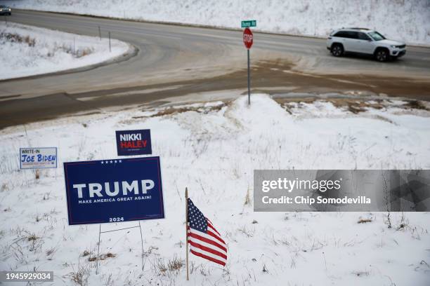 Campaign signs for Republican presidential candidates former President Donald Trump and former UN Ambassador Nikki Haley stand next to a sign asking...
