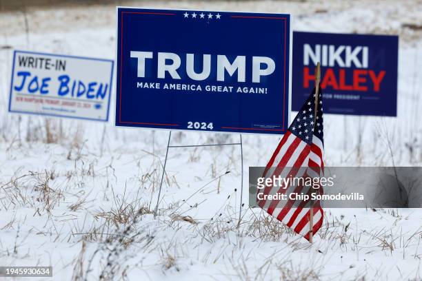 Campaign signs for Republican presidential candidates former President Donald Trump and former UN Ambassador Nikki Haley stand next to a sign asking...