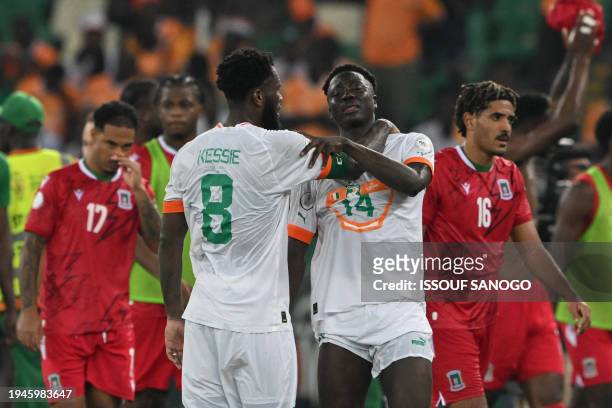 Ivory Coast's midfielder Franck Kessie consoles Ivory Coast's forward Oumar Diakite after Equatorial Guinea won the Africa Cup of Nations 2024 group...