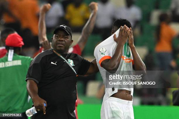 Ivory Coast's forward Karim Konate reacts after Equatorial Guinea won the Africa Cup of Nations 2024 group A football match between Equatorial Guinea...
