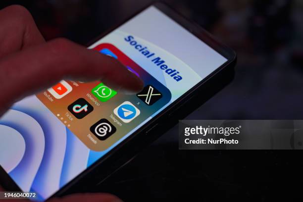 The logo of X is being displayed on a smartphone among other social media networks in this photo illustration in Brussels, Belgium, on January 22,...