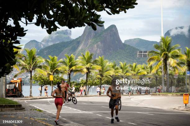 People are walking and jogging on Avenida Vieira Souto by Ipanema Beach in Rio de Janeiro, Brazil, on January 21, 2024.