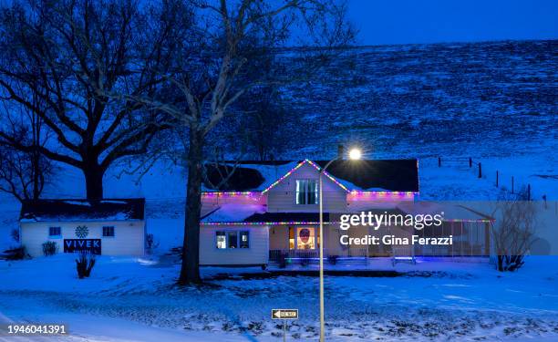 Photograph of Donald Trump's face hangs in the living room window over the front porch while an election banner for Vivek Ramaswamy hangs on the...