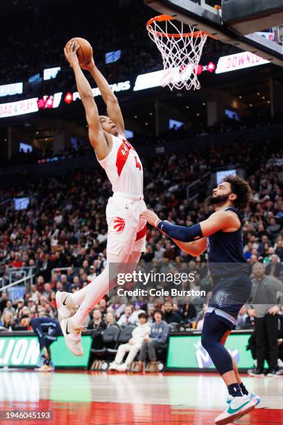 Scottie Barnes of the Toronto Raptors dunks against David Roddy of the Memphis Grizzlies in the first half at Scotiabank Arena on January 22, 2024 in...