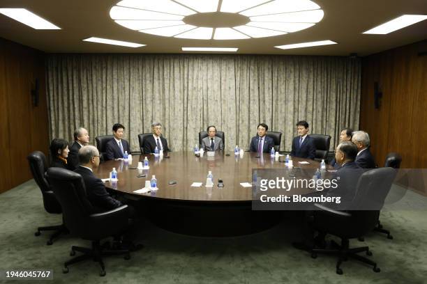 Kazuo Ueda, governor of the Bank of Japan , center, attends a monetary policy meeting with deputy governors, members of the policy board and...