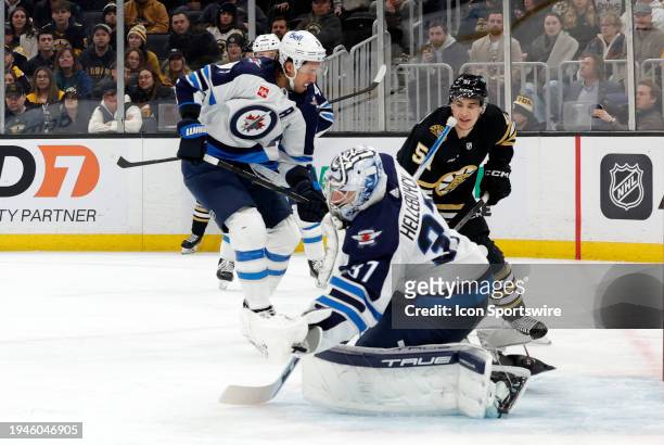 Winnipeg Jets goalie Connor Hellebuyck makes a glove save during a game between the Boston Bruins and the Winnipeg Jets on January 22 at TD Garden in...
