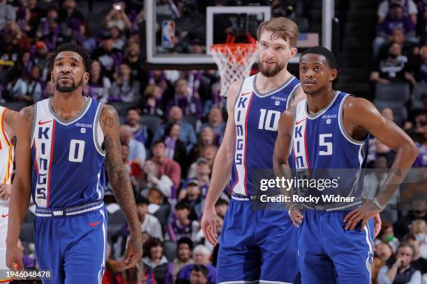 Malik Monk, Domantas Sabonis and De'Aaron Fox of the Sacramento Kings looks on during the game against the Atlanta Hawks on January 22, 2024 at...