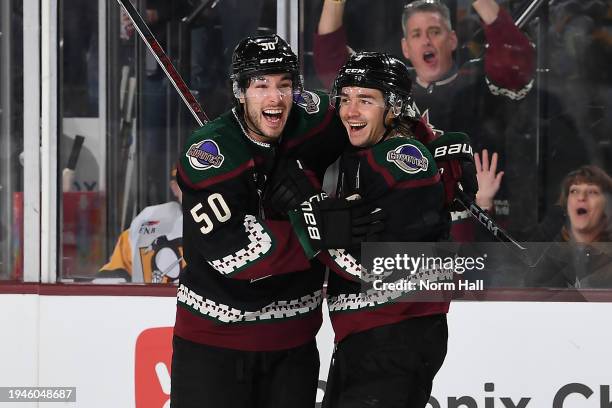 Clayton Keller of the Arizona Coyotes celebrates with teammate Sean Durzi after a goal scored by Lawson Crouse during the third period of the game...