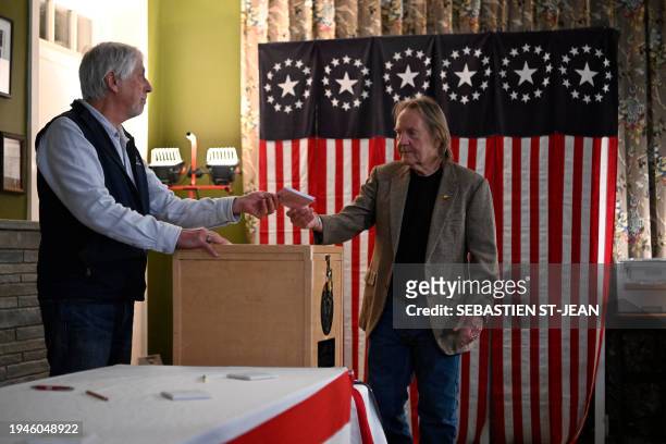 Voter casts his ballot in the First-in-the-Nation midnight vote for the New Hampshire primary elections in the Living Room of the Tillotson House at...