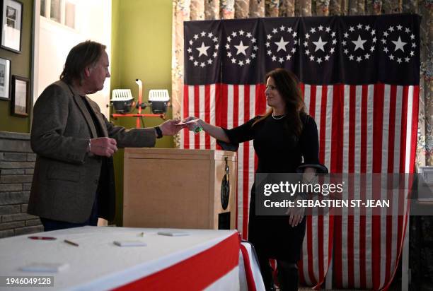 Voter casts her ballot in the First-in-the-Nation midnight vote for the New Hampshire primary elections in the Living Room of the Tillotson House at...