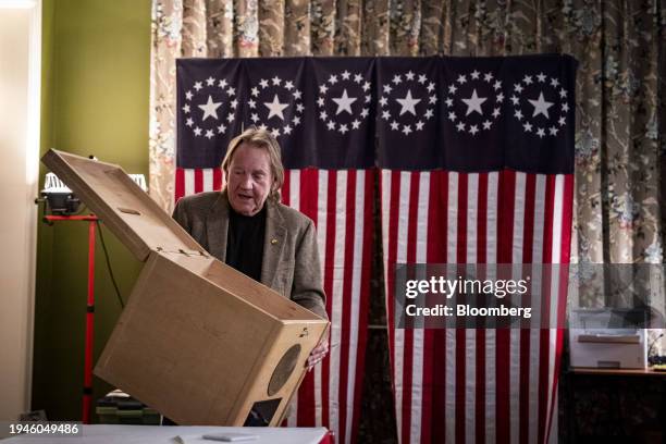 Tom Tillotson, Town moderator, shows the media an empty ballot box before the first-in-the-nation midnight vote at the Tillotson House at The Balsams...