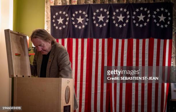 Voting official opens the ballot box to count the votes in the First-in-the-Nation midnight vote for the New Hampshire primary elections in the...