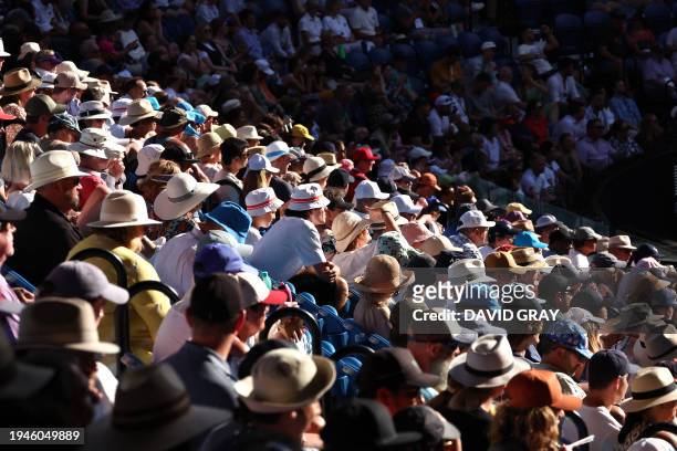 Tennis fans watch the men's singles quarter-final match between USA's Taylor Fritz and Serbia's Novak Djokovic on day 10 of the Australian Open...