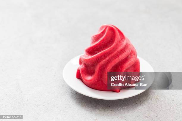 frozen dessert. strawberry ice cream, sorbet in the form of french chantilly cream. on a plate. light grey background. copy space - whip cream dollop stock pictures, royalty-free photos & images