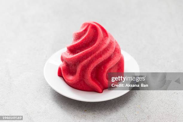 strawberry ice cream, sorbet in the form of french chantilly cream. on a plate. light grey background. close-up. - whip cream dollop stock pictures, royalty-free photos & images