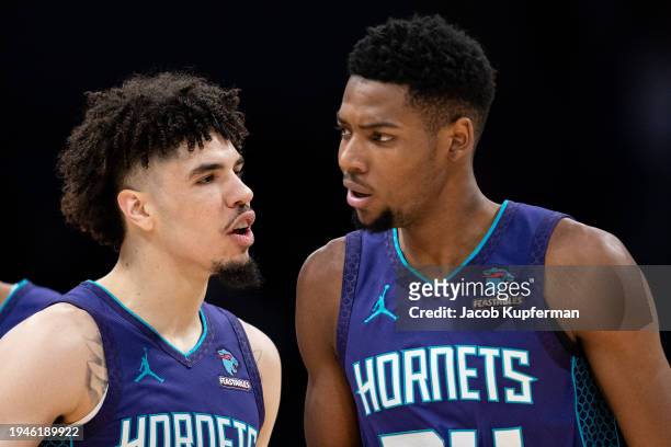 LaMelo Ball of the Charlotte Hornets reacts with Brandon Miller in the first quarter during their game against the San Antonio Spurs at Spectrum...