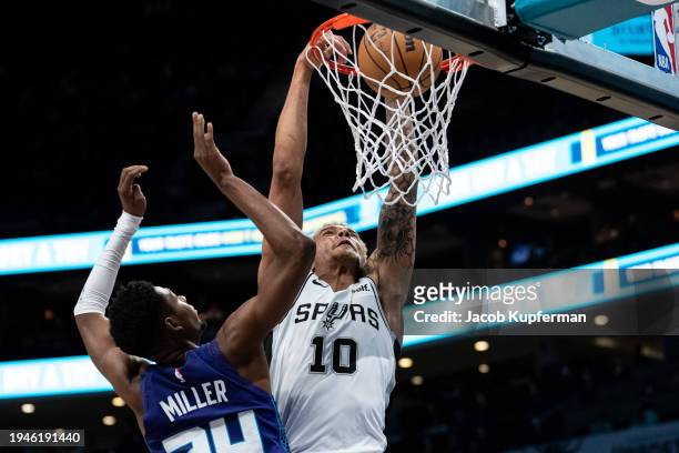 Jeremy Sochan of the San Antonio Spurs dunks the ball while guarded by Brandon Miller of the Charlotte Hornets in the first quarter during their game...