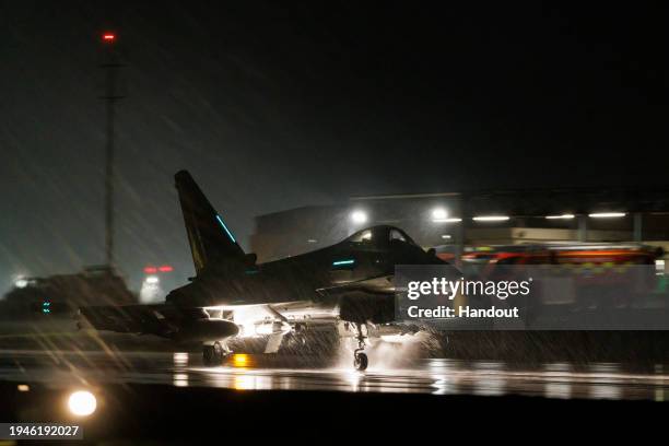 In this handout image provided by the UK Ministry of Defence, a Royal Air Force Typhoon FGR4 takes off to carry out air strikes against Houthi...