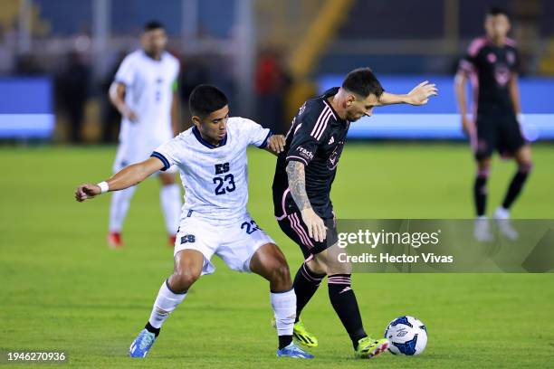 Lionel Messi of Inter Miami FC battles for possession with Melvin Cartagena of El Salvador during a friendly match between El Salvador and Inter...