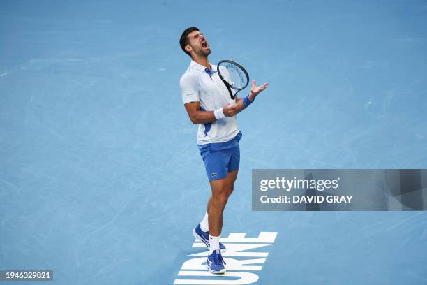 Serbia's Novak Djokovic reacts on a point against USA's Taylor Fritz during their men's singles quarter-final match on day 10 of the Australian Open...