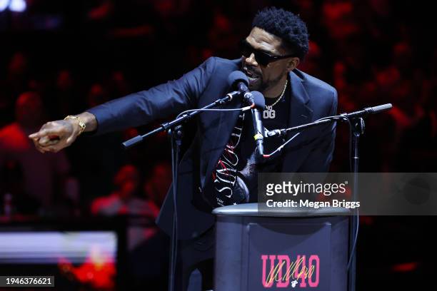 Former Miami Heat player Udonis Haslem addresses the crowd during his jersey retirement ceremony at halftime of a game between the Atlanta Hawks and...