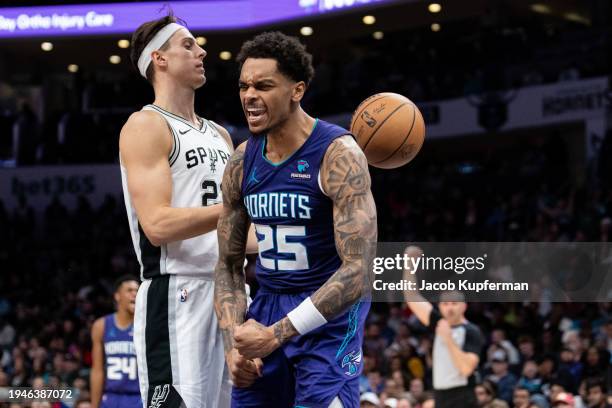 Washington of the Charlotte Hornets reacts while Zach Collins of the San Antonio Spurs looks on in the fourth quarter during their game at Spectrum...