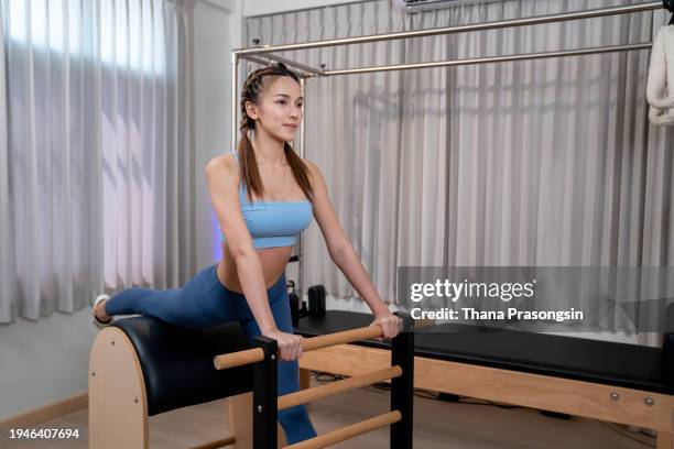 Premium Photo  Female doing ballet stretch on pilates cadillac