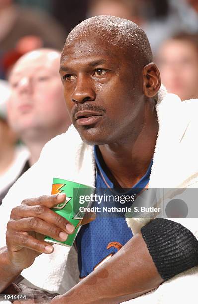 Michael Jordan of the Washington Wizards quenches his thirst as he takes a rest on the bench in his farewell game in the city of Boston during the...
