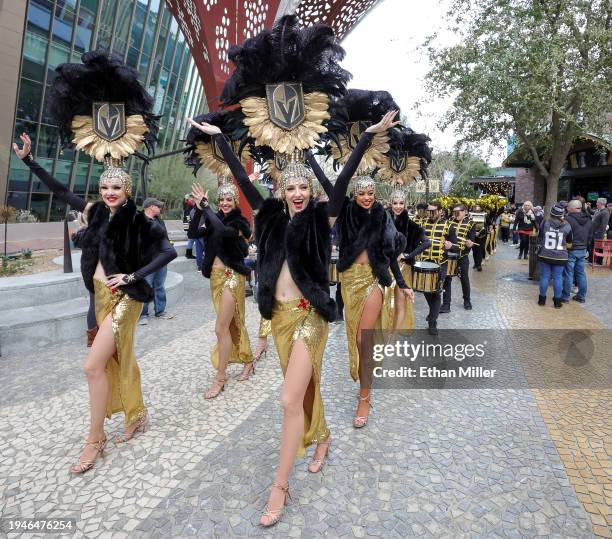 Members of the Golden Belles showgirl team and the Vegas Golden Knights Knight Line by Drumbots participate in The March to the Fortress at The Park...