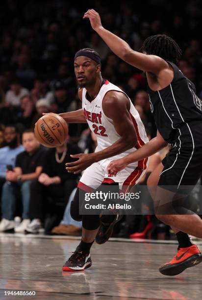 Jimmy Butler of the Miami Heat in action against Cam Thomas of the Brooklyn Nets during their game at Barclays Center on January 15, 2024 in New York...