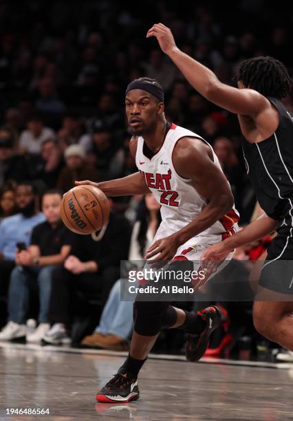 Jimmy Butler of the Miami Heat in action against Cam Thomas of the Brooklyn Nets during their game at Barclays Center on January 15, 2024 in New York...
