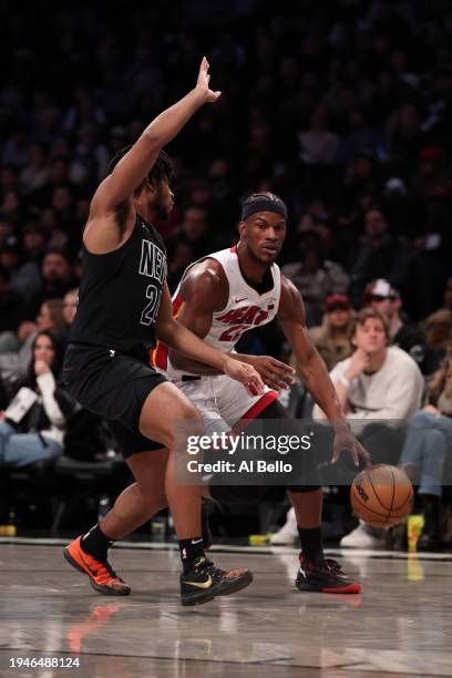 Jimmy Butler of the Miami Heat in action against Cam Thomas of the Brooklyn Nets during their game at Barclays Center on January 15, 2024 in New York...