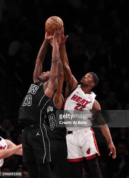 Dorian Finney-Smith of the Brooklyn Nets and Jimmy Butler of the Miami Heat battle for the ball during their game at Barclays Center on January 15,...