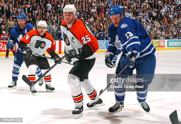 Keith Primeau and Sami Kapanen of the Philadelphia Flyers skate against Mats Sundin and Gary Roberts of the Toronto Maple Leafs during NHL game...