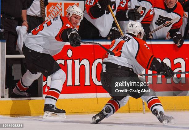 Keith Primeau helps injured Sami Kapanen of the Philadelphia Flyers against the Toronto Maple Leafs during NHL game action on May 4, 2004 at Air...