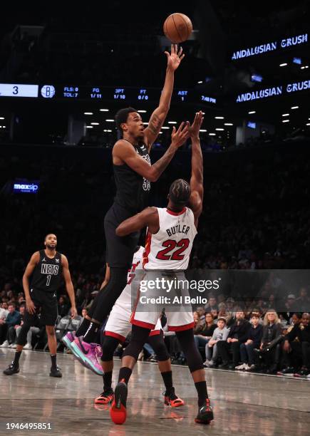 Nic Claxton of the Brooklyn Nets shoots against Jimmy Butler of the Miami Heat during their game at Barclays Center on January 15, 2024 in New York...