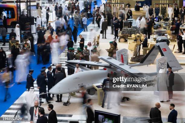 Visitors walk among displays at the UMEX Exhibition showcasing drones, robotics, and unmanned sytems at the Abu Dhabi National Exhibition Centre in...