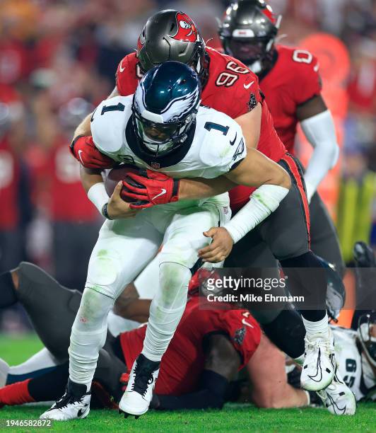 Jalen Hurts of the Philadelphia Eagles is sacked by Greg Gaines of the Tampa Bay Buccaneers during the NFC Wild Card game at Raymond James Stadium on...