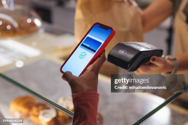 contactless payment by phone - pos machine stock pictures, royalty-free photos & images