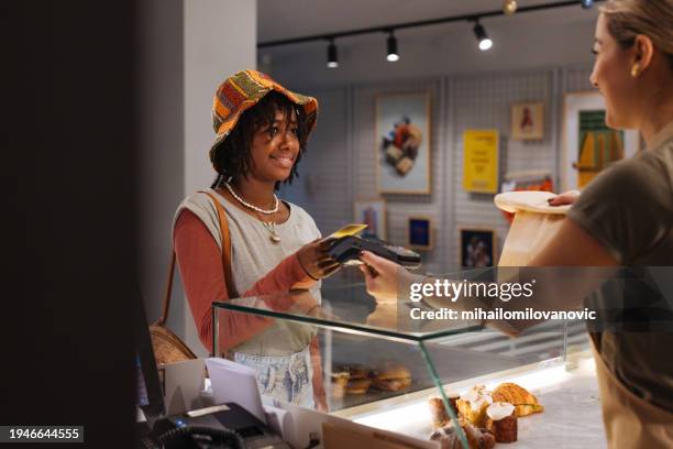 teenage girl paying in a restaurant - pos machine stock pictures, royalty-free photos & images