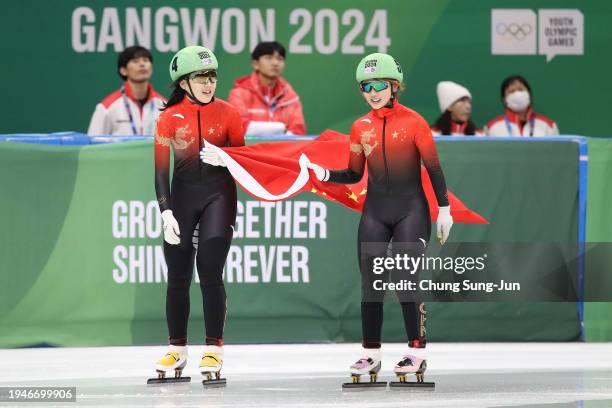 Yang Jingru of China and Li Jinzi of China celebrate after the Women 1500m Final A during a day one of the Winter Youth Olympic Games at Gangneung...