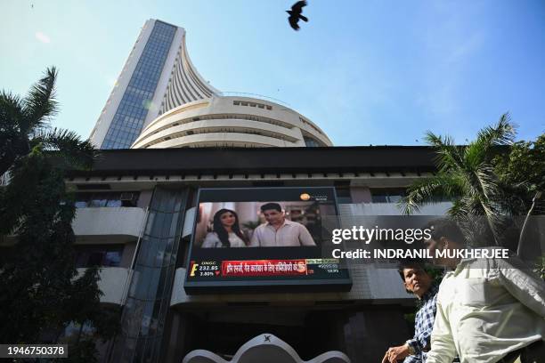 Pedestrians walk past the Bombay Stock Exchange building in Mumbai on January 23, 2024. India's stock market has edged out Hong Kong to become the...