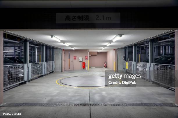 quiet evening at a yokohama parking garage - luce fluorescente foto e immagini stock