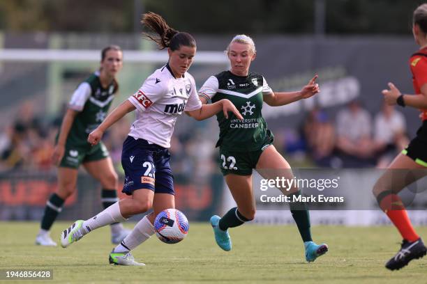 Rachel Lowe of Victory and Barrie Clough of United compete for the ball during the A-League Women round 13 match between Canberra United and...